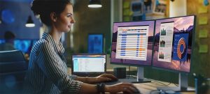 Beautiful Female Video Editor Works with Footage on Her Personal Computer, She Works in Creative Office Studio.